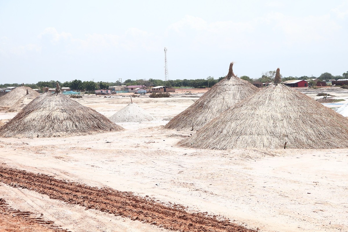 Rows of thatched salt mounds waiting to be harvested on the Songor Lagoon